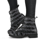 black vintage sheet music lace up combat boots.  Black grungy vintage writing background over printed with sheet music in white.